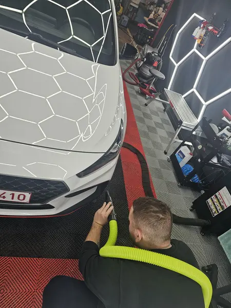 Aspiration près du pare-chocs d’un véhicule blanc — Belgium Detailing Academy, formation automobile à Manage